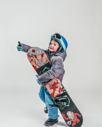 Oxygène Ski & Snowboard School Child Holding Snowboard 2