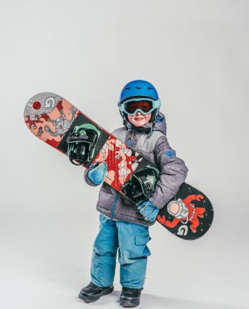 Oxygène Ski & Snowboard School Child Holding Snowboard