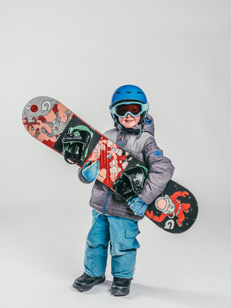 Oxygène Ski & Snowboard School Child Holding Snowboard