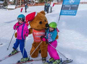 ollie oxygene bear hugging children skiing